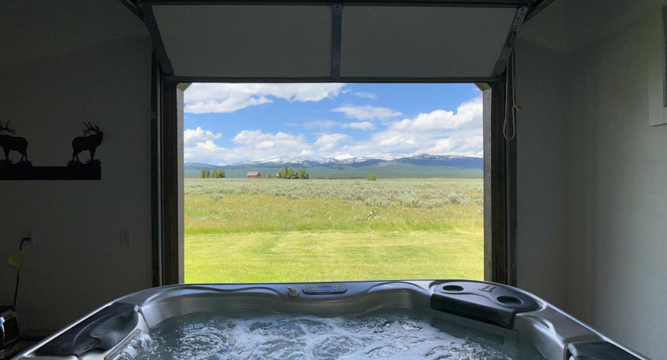 Unwind in the bubbling hot tub while framing panoramic views of the open plains and majestic distant mountains.