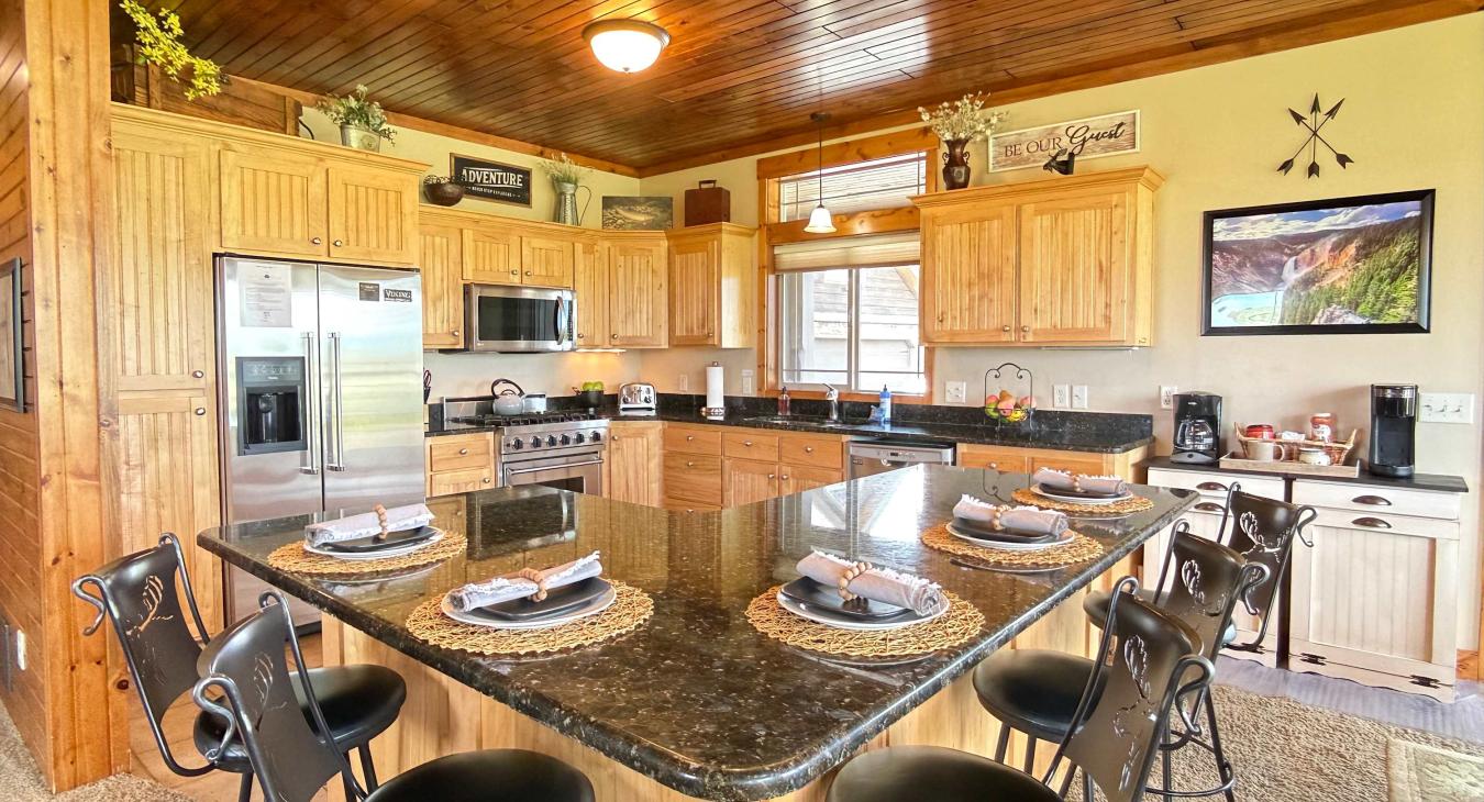 Cook and chat together around the expansive kitchen island. This fully equipped space features gorgeous granite countertops and counter seating.