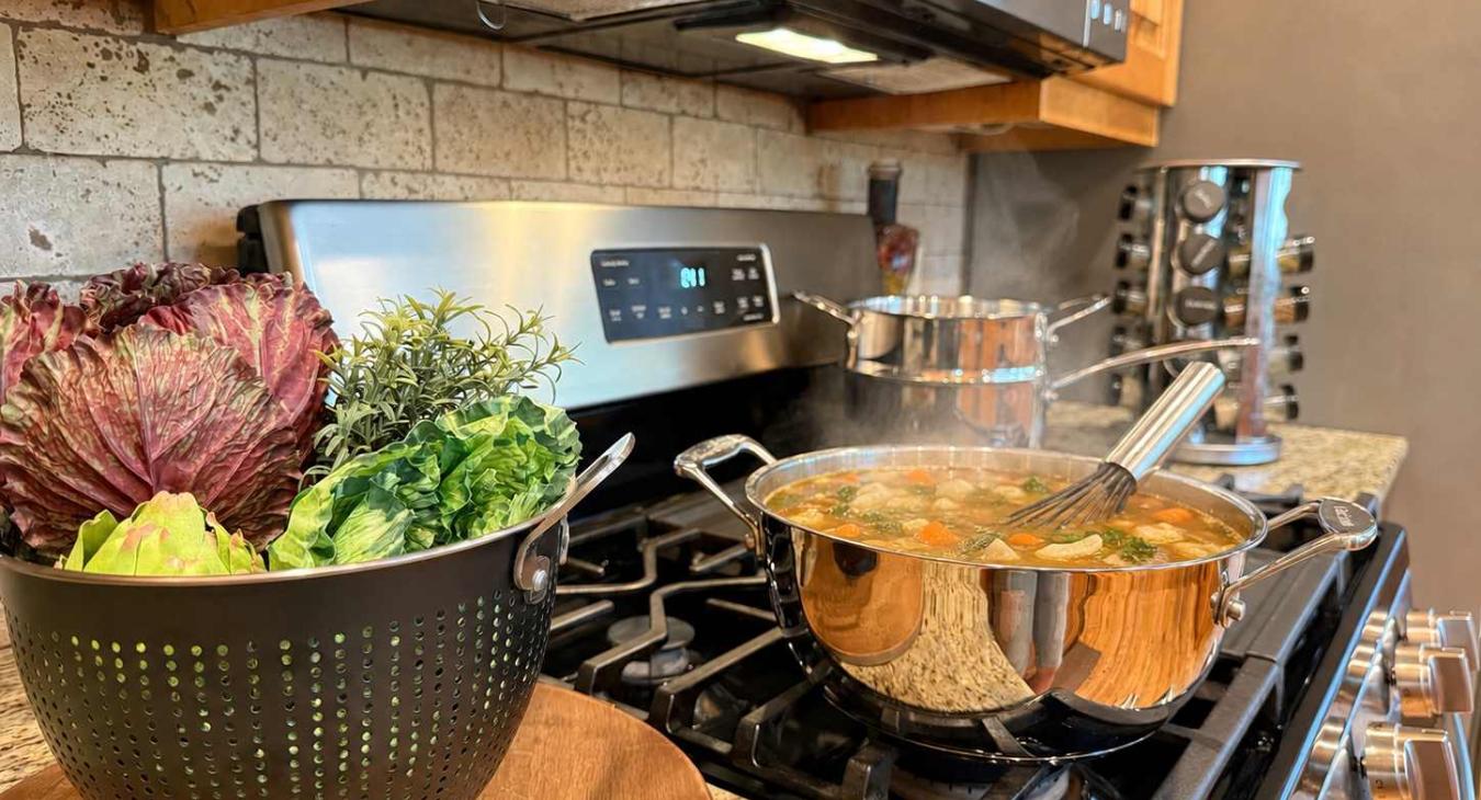 gas range with spices, pots and pans, utensils and small appliances.
