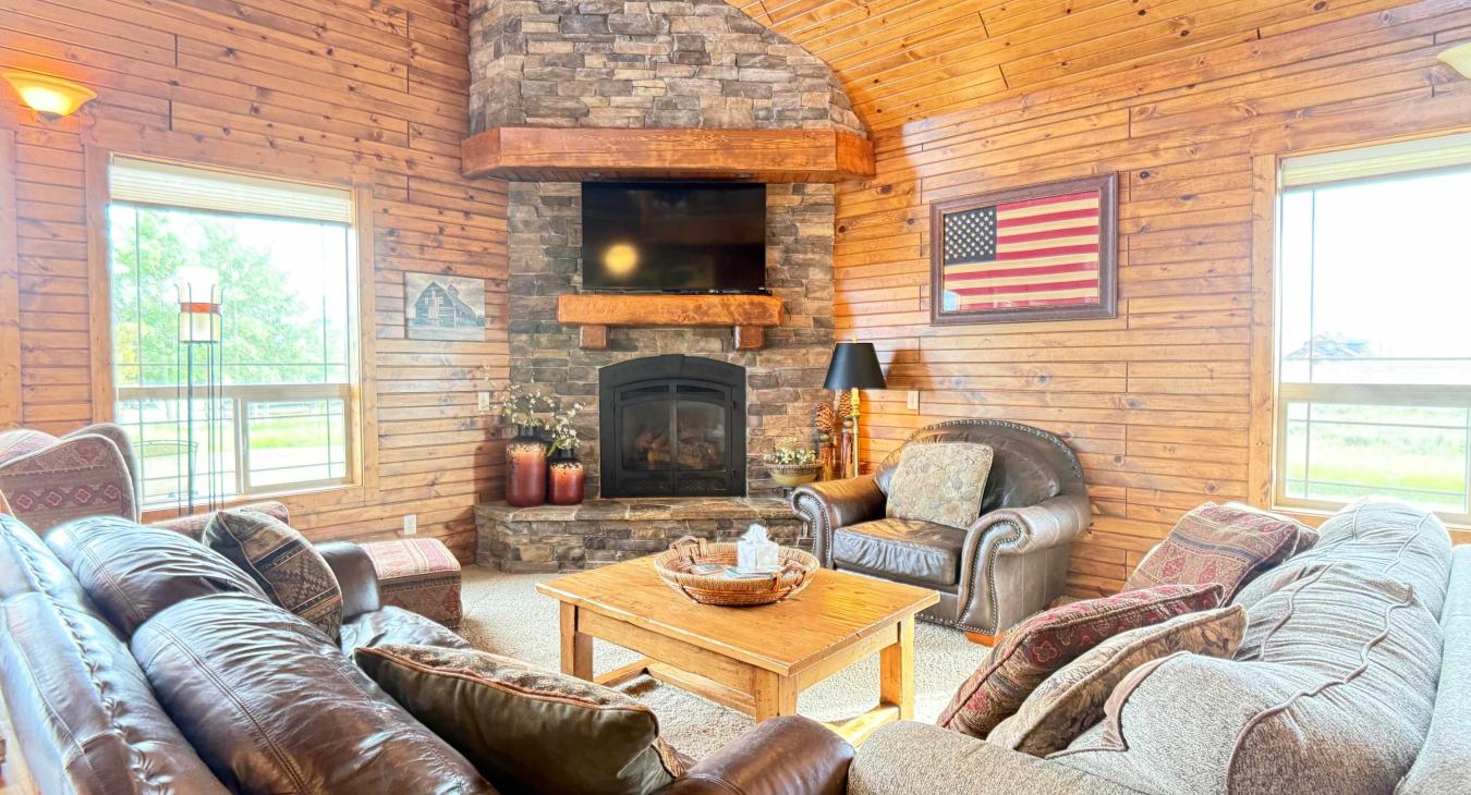 Experience cozy cabin luxury in this spacious living room featuring high
