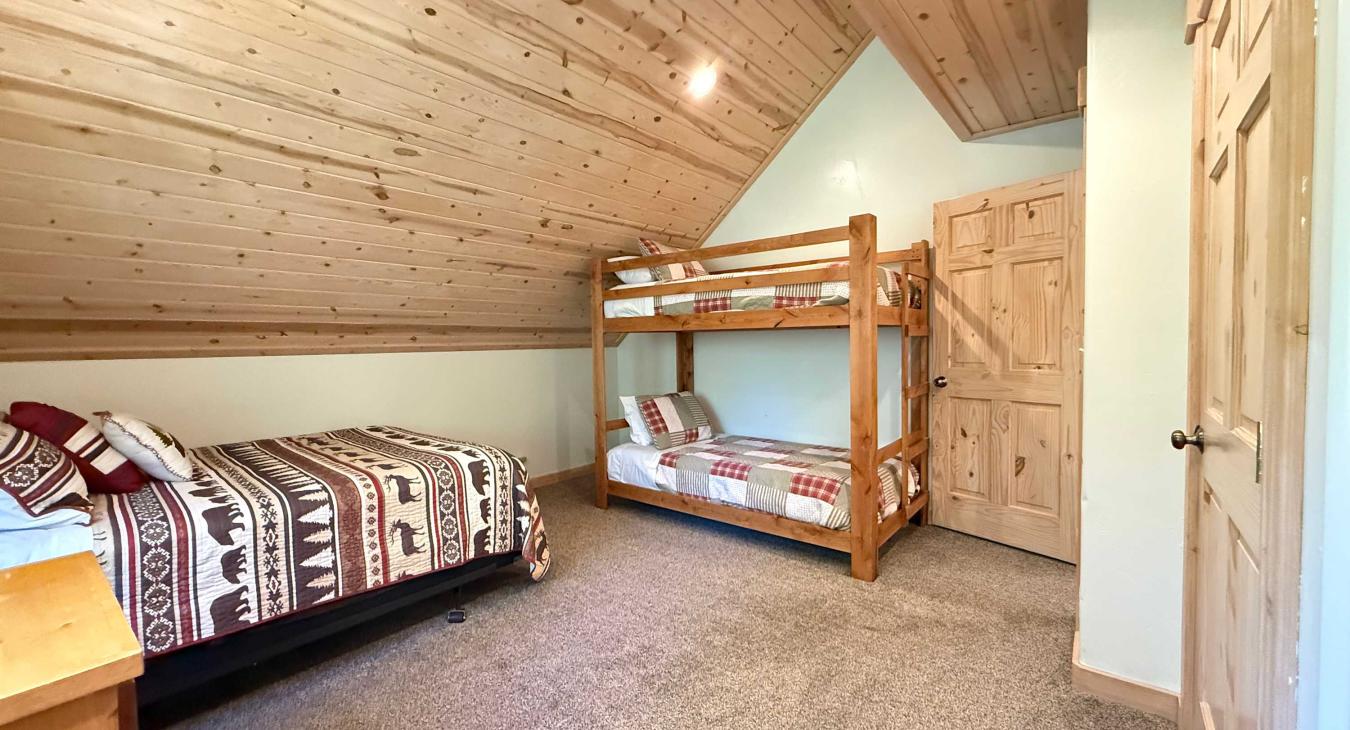 Bedroom #1 located upstairs with a Queen and a bunk bed.