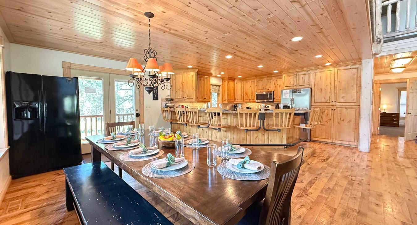 Dining table with extra fridge looking into the kitchen.