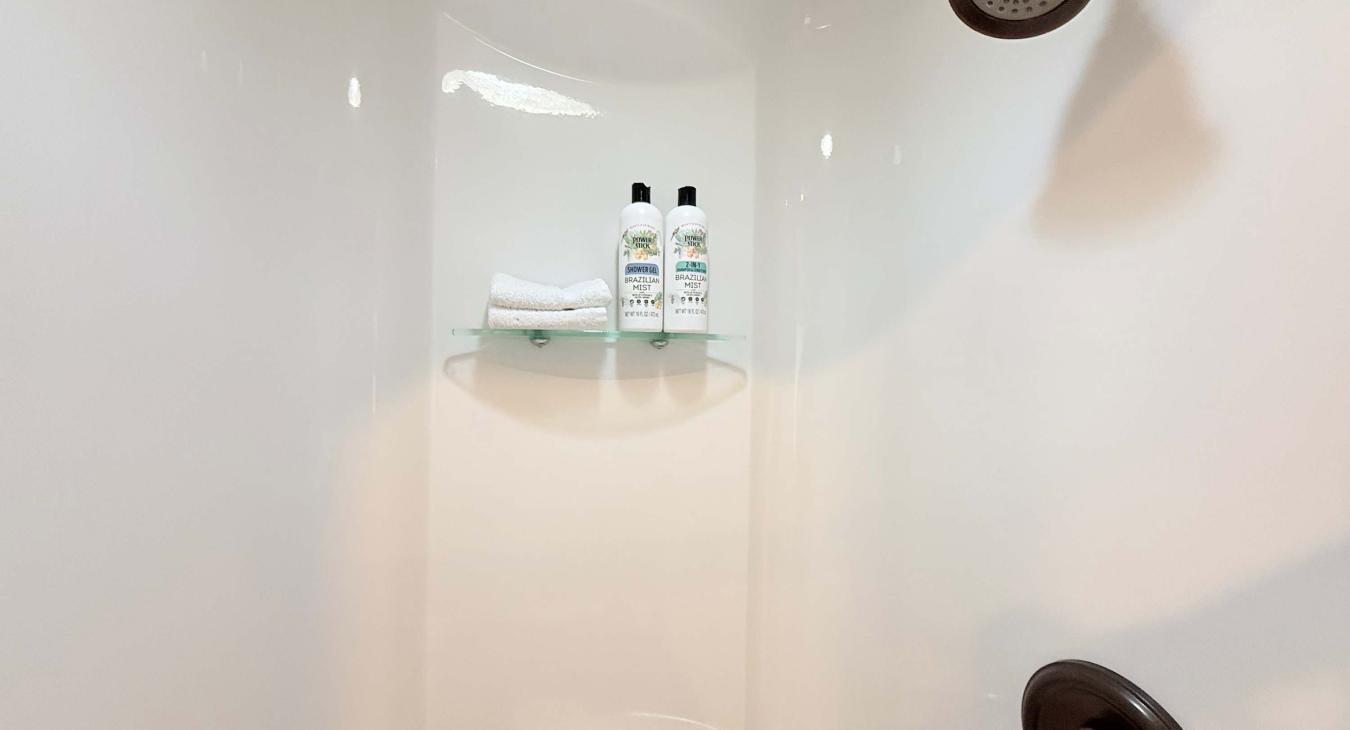 Refresh after a day of outdoor adventure in the clean, modern walk-in shower, complete with built-in shelving for your bath essentials.