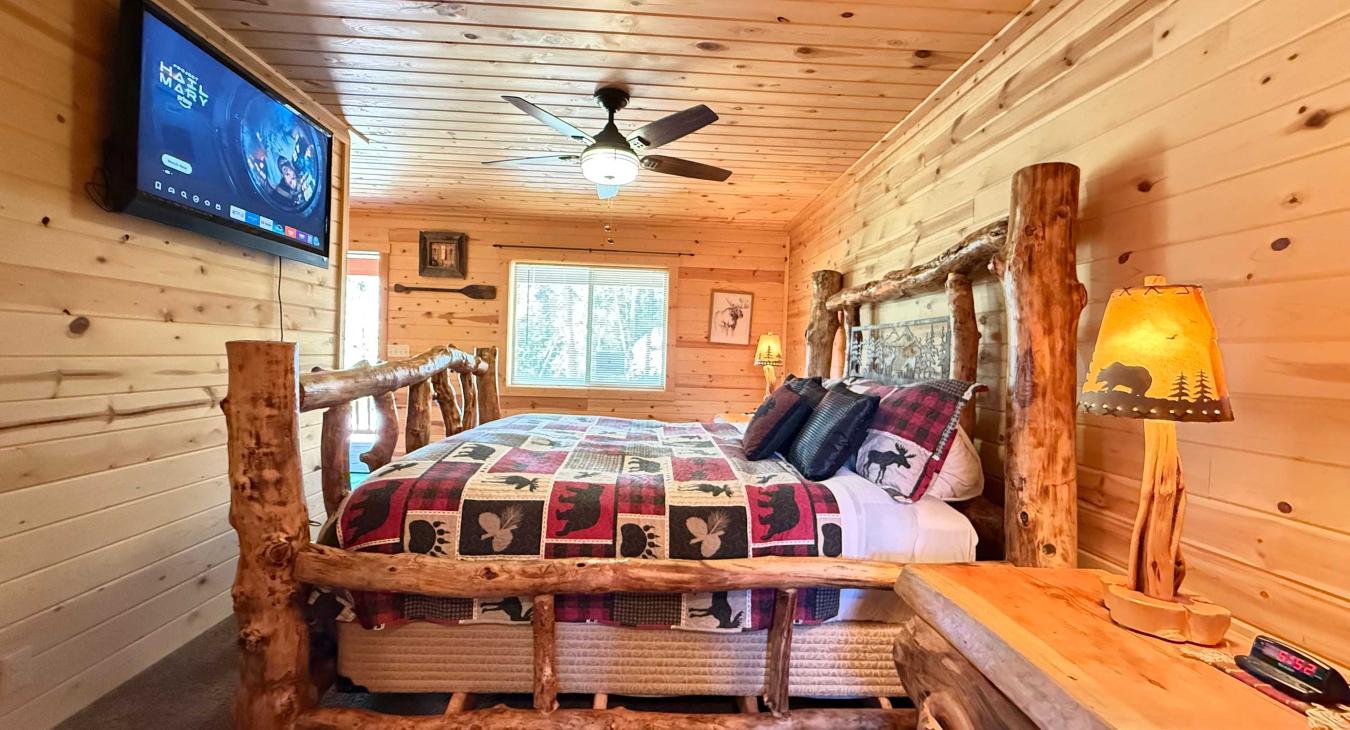Enjoy a relaxing morning in bed while watching your favorite shows on the large wall-mounted Smart TV, complete with natural light streaming through the window.