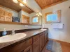 Shared bathroom on the main floor with shower tub combo, toilet, and sink vanity.
