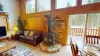 In the center of the room, a stone fireplace rises dramatically, perfect for curling up on chilly evenings.