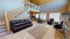 Open living room that can lead you upstairs or to the kitchen.