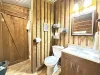 Bathroom equipped with towels, toilet, sink, and shower.