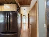 Hallway view of the kitchen and access to the bathroom and laundry room ahead.