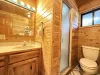 Full bathroom on main floor with sink, toilet, and standing shower.