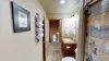 Towels, toilet paper, shampoo, conditioner, and body wash are provided in the bathroom.