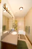 Downstairs shared bathroom with shower tub combo, toilet, and sink vanity.
