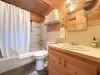 Full bathroom on the main level with shower/tub, toilet, and sink vanity.