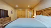 Queen bed and closet located in this room.