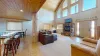 The open kitchen blends seamlessly into the cabin's cozy living area, creating a welcoming space perfect for gathering and unwinding.