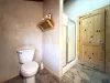 Upstairs level bathroom with toilet, sink vanity, and standing shower.