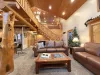 Main level living room with seating and a fireplace for everyone to enjoy.
