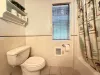 Full bathroom with shower tub combo, sink, toilet, and vanity storage. Towels are provided.