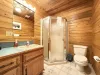 Full bathroom with standing shower, toilet, and sink.