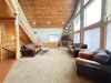 Big open living area with seating, tv for entertainment, and a fireplace.