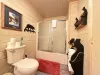 Common bathroom in the hallway. Spacious countertop and full tub and shower.