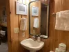 Equipped with a shower tub combo, toilet, and sink.
