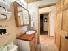 Downstairs bathroom with a shower tub combo, toilet, and sink vanity.