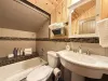 Upstairs bathroom with shower/tub, toilet, and sink. Fresh clean towels are provided.