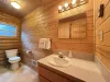 Upstairs bathroom with shower/tub, toilet, and sink.