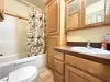 Common bathroom located in the hallway. Includes shower tub combo, toilet, and sink vanity.