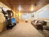 Basement living room with seating and tv for entertainment.