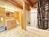 Full bathroom downstairs with sink, toilet, and shower tub combo.