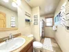 Upstairs bathroom with shower tub combo, toilet, and sink vanity.