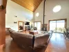 Living room on the main floor with large couch, television, and fireplace.