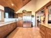 The openness of the kitchen makes it easy to chat with friends or family while cooking, or to catch the glow of the fire and the sound of laughter as you move between the rooms.