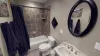 Upstairs bathroom with a shower tub combo, toilet, and sink.
