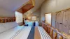 Tucked discreetly into one corner is the ensuite bathroom, accessible through a wooden frame door.