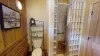 Bathroom #2 located upstairs with a standing shower, toilet, and sink vanity.