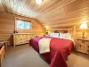 King upstairs bedroom with dresser and small closet.