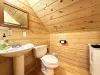 Upstairs half bathroom with toilet and sink.