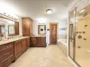 Ensuite Master Bathroom with tub, standing shower, toilet, bidet, and double sinks.