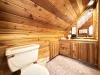 Bathroom with shower, sink vanity, and toilet.
