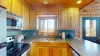 The kitchen is equipped with stainless steel appliances, cookware, pots and pans, dishes, and basic cooking essentials.