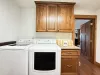 Laundry room with full size washer and dryer with laundry soap provided.