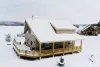 Aerial view of the outside of the cabin in the winter.