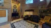 Spacious living room comes equipped with a T.V. and comfortable couches.