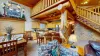 The interior is open-concept, blending the living area with a kitchen and dining space, giving it a warm, communal feel.