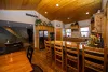 Dining area with a full dining room table and additional seating at the kitchen.