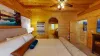 The room’s decor includes subtle touches of luxury, such as an area rug under the bed, a sleek dresser with modern accents, and framed art on the walls that add personality without overwhelming the space.
