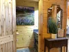 Imagine stepping into a cozy half bathroom in a cabin, designed to blend rustic charm with functionality.